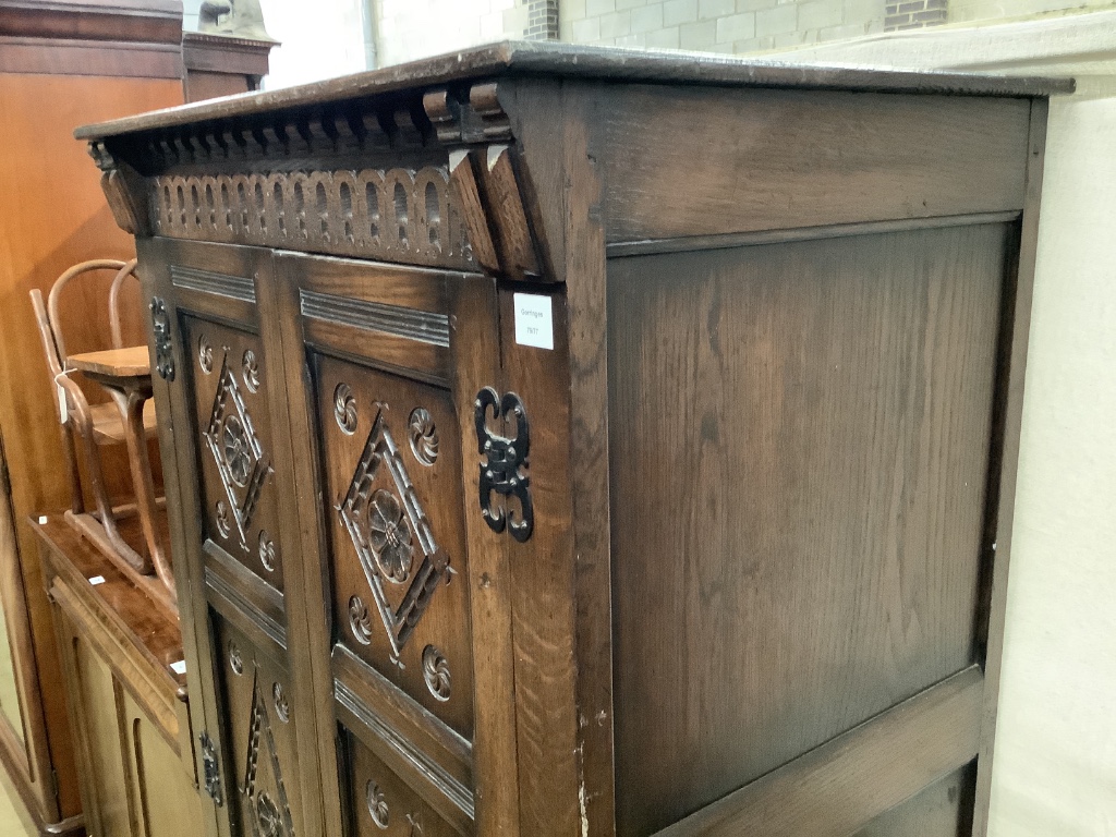 An 18th century style carved panelled oak wardrobe, width 95cm depth 58cm height 174cm